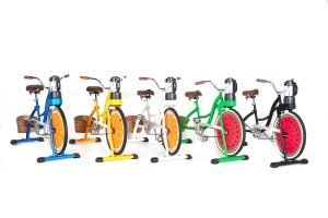 Line of stationary bicycles fitted with blenders, so the blender runs when the user pedals the bike.